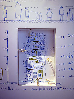 Sketches made directly on the partition walls, with small notches for plastic people.