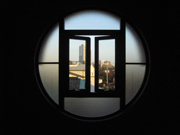 Through the round window on the second floor, we can see the context changing.
